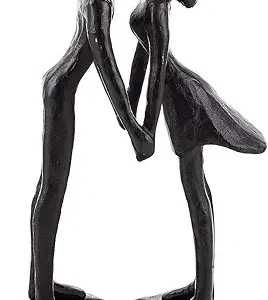A minimalist dark bronze or cast iron sculpture of a man and a woman holding hands and kissing, mounted on a rustic circular base against a white background.