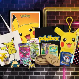 A magical collection of Pokémon merchandise from a Pokébox subscription box, featuring trading cards, stationery, a plush pouch, and custom coasters.