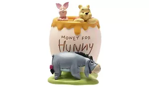 A Disney Winnie the Pooh ceramic piggy bank shaped like a honey pot.