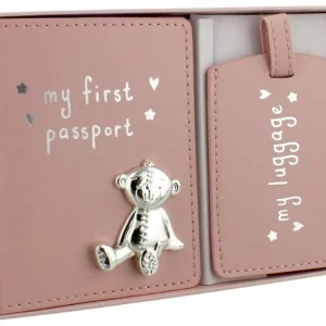 A blush pink faux-leather Button Corner My First Passport & Luggage Tag Set displayed inside its white presentation box, showcasing a polished silver teddy bear emblem on the front cover.