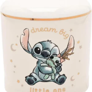A white ceramic Disney Stitch Magical Beginnings Money Bank with a gold-rimmed top, decorated with a pencil-sketch illustration of baby Stitch holding a Scrump doll.