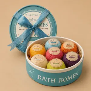 A round, blue Aofmee Bath Bombs gift box opened to reveal seven brightly colored, wrapped bath bombs nestled inside.