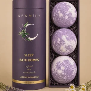 A NEW MIUZ Sleep Bath Bombs Gift Set with its purple tube packaging next to a tray holding three lavender and chamomile bath bombs.