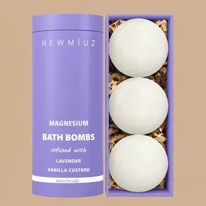 Packaging for NEW MIUZ Magnesium Bath Bombs in a purple tube next to a box containing three white lavender and vanilla custard bath bombs.