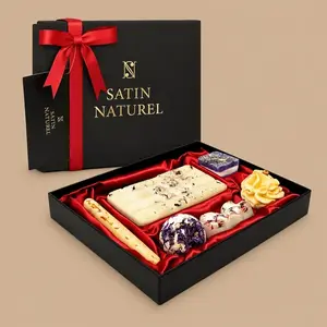 A Satin Naturel Luxury Gift Box filled with seven handmade, vegan bath pralines on a red satin lining.