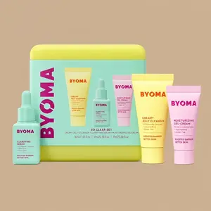 The BYOMA So Clear Set skincare kit, displaying its yellow and blue storage case alongside three travel-sized products.