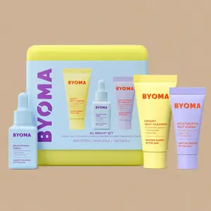 The BYOMA So Bright Set skincare kit, showcasing its yellow storage case alongside three travel-sized products on a beige background.