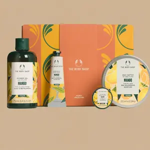 The Body Shop Mango Collection body care gift set, showcasing four individual mango-scented products arranged in front of an orange and yellow gift box.