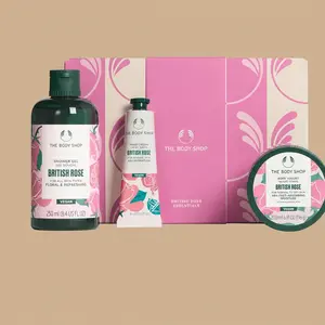 The Body Shop British Rose Essentials body care gift set, showcasing three individual rose-scented products arranged in front of a pink gift box.