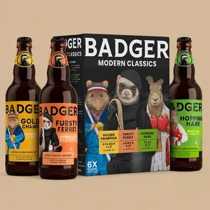 A Badger Beers Modern Classics 6-bottle gift set featuring three distinct ale bottles standing in front of their illustrated presentation box.