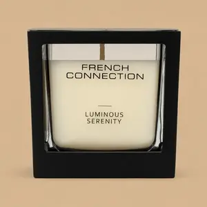 A French Connection Luminous Serenity candle in square glass and black packaging.