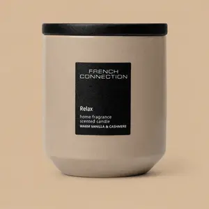 A French Connection Relax Warm Vanilla & Cashmere ceramic jar candle with a black lid.