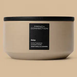 A wide French Connection Relax Warm Vanilla & Cashmere ceramic bowl candle with a black lid.