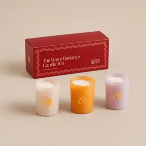 A Bloom & Wild Warm Radiance three-piece frosted glass jar candle gift set with its red box.