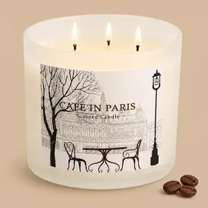 A lit "Cafe in Paris" three-wick scented candle beside coffee beans.