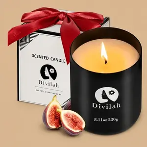 A lit "Divilah" scented candle in a black jar with fresh figs and a gift box.