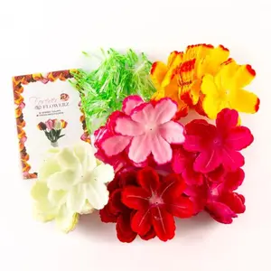 An assortment of colorful faux flower petals, green plastic stems, and an instruction card from a Forever Flowerz craft kit.