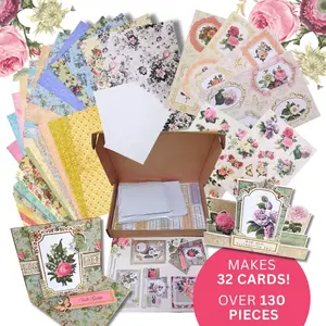 An unboxed craft kit containing patterned floral papers, die-cut sentiment toppers, cards, and assembly instructions from the Craft Buddy Eleganza Papercrafting Kit