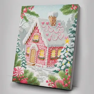 A completed vertical diamond painting canvas depicting a snowy pink gingerbread-style cottage decorated for Christmas, surrounded by pine branches with frosted details and striped candy ornaments.