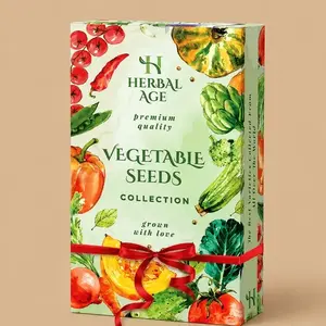 A white and green box for the Herbal Age Vegetable Seeds Collection, featuring watercolor illustrations of various fresh vegetables and tied with a red ribbon gift bow.