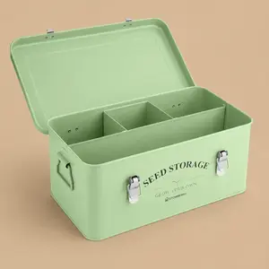 An open, sage green metal STOWBERRY Seed Storage Box with four interior compartments, side handles, and dual front safety latches.