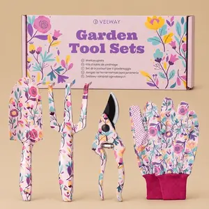 A 4-piece Velway floral garden tool set featuring a hand trowel, a cultivator fork, pruning shears, and protective gloves, all matching a pink and purple wildflower pattern next to its stylized gift box.