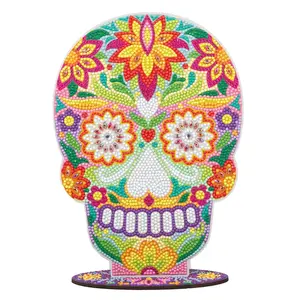 A vibrant Mexican-style sugar skull rhinestone craft kit featuring bright floral and geometric patterns made from sparkling gem dots.
