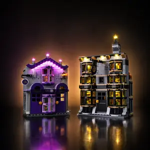 A completed LEGO Harry Potter Ollivanders and Madam Malkin's Robes set fully illuminated with a custom LED light kit, casting vibrant purple and warm golden light against a plain black background.