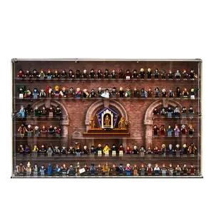 A large, wall-mounted acrylic display case filled with a massive collection of LEGO Harry Potter minifigures arranged on clear shelves in front of a printed backdrop depicting the brick arches of Hogwarts.