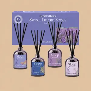 A set of four purple reed diffusers from the "Sweet Dream Series" arranged in front of their matching lavender-themed box.