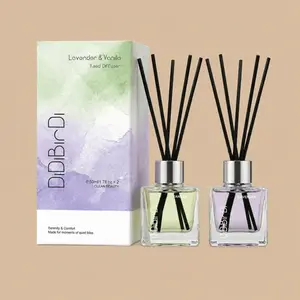 A DiDiBirDi Lavender & Vanilla reed diffuser set featuring a watercolor-styled gift box alongside two clear glass diffuser bottles with black reeds.