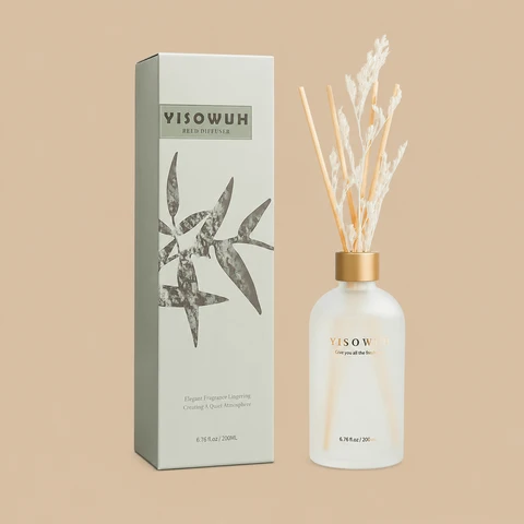 A YISOWUH reed diffuser set featuring a minimalist frosted glass bottle with wooden sticks, white dried florals, and a sage green gift box.