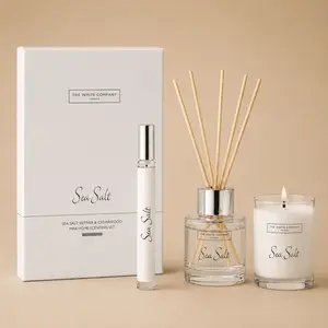 The White Company Sea Salt home fragrance gift set showing a mini diffuser, room spray, and single-wick candle with crisp sea salt, vetivert, and cedarwood scent notes.