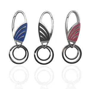 Three sleek car keychains with carabiner clips and wing-like accent panels in blue, black, and red, arranged side by side.