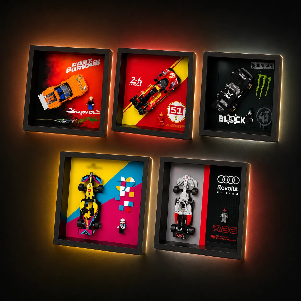 A collection of five individual, square black LEGO Speed Champions shadow box display frames mounted on a dark wall, each showcasing a different vehicle model with a custom-themed graphic backing and ambient warm backlighting.