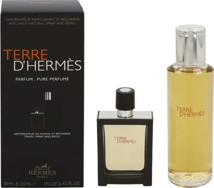 A gift set of Terre d'Hermès Pure Perfume, featuring a black box, a small travel spray bottle, and a tall glass refill bottle.