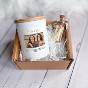 A personalized birthday gift box containing a white jar candle with a custom photo label dedicated "To my bestie", paired with a small glass jar of matches in white shredded paper packaging.