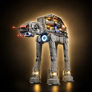 A completed LEGO Star Wars UCS AT-AT walker model fully illuminated with a custom LED light kit, showcasing an exposed multi-tier cockpit and troop cabin interior against a dark background.