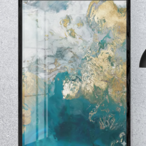 A vertical black-framed abstract painting featuring fluid swirls of deep teal, light blue, white, and shimmering metallic gold veins, leaning against a textured gray wall.