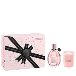 Viktor & Rolf Flowerbomb fragrance and lifestyle gift set featuring a light-pink water droplet textured box wrapped in branded black ribbons, a diamond grenade perfume bottle, and a soft pink votive candle.