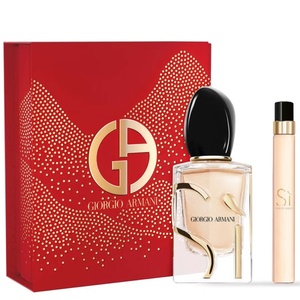 Giorgio Armani Sì fragrance set featuring a bright red box with a gold monogram logo and stardust patterns alongside a clear perfume bottle and travel spray.