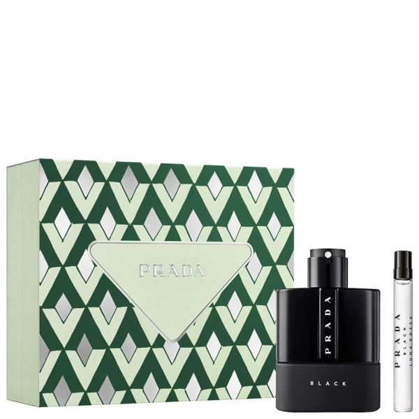 Prada Luna Rossa Black gift set featuring a green geometric triangle patterned box, an opaque black cologne bottle, and a slim travel spray vial.
