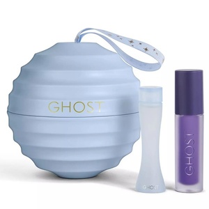 Ghost The Fragrance miniature festive bauble set featuring a textured periwinkle blue tin box, a frosted hourglass perfume bottle, and a matching purple lip oil tube.
