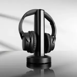 "A pair of black over-ear wireless headphones resting vertically on a tall, sleek black and silver charging tower dock, casting a soft reflection on a glossy surface."